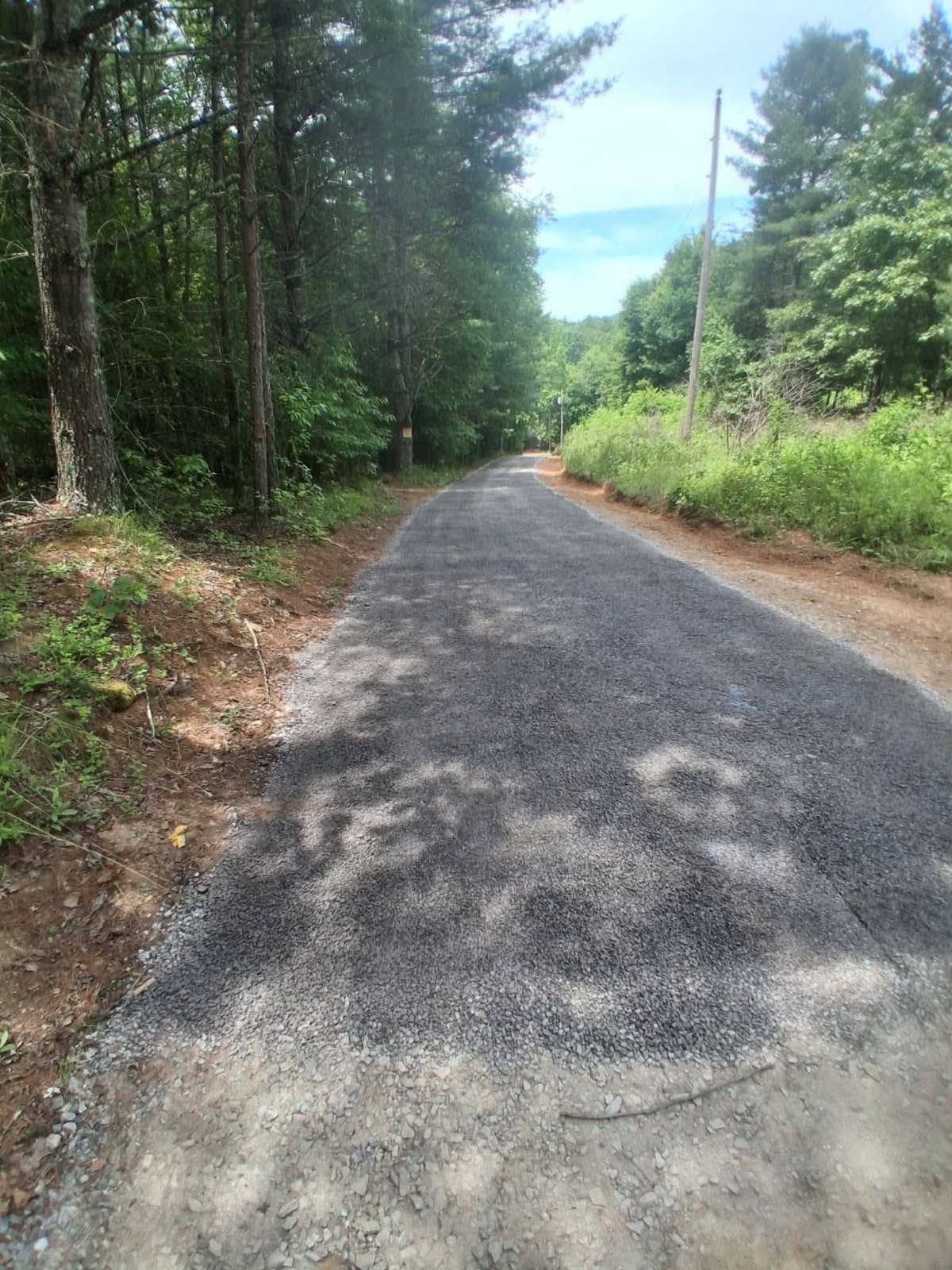 Smooth new tar-and-chip drive in the western NC mountains, a surface that plows cleanly