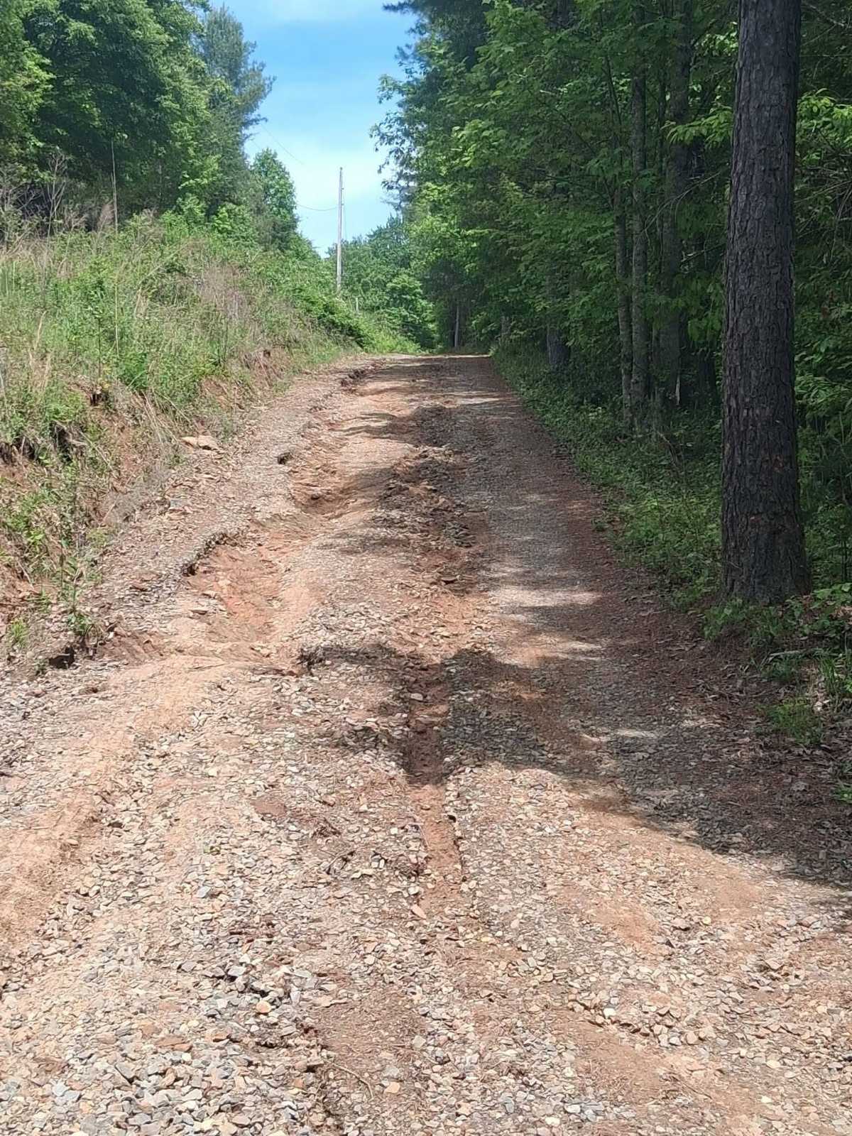 A washed-out, rutted mountain road in the Cherokee County, NC area before chip sealing